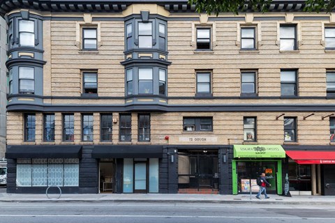 A building with a green awning and a sign that says "12 GOOD".