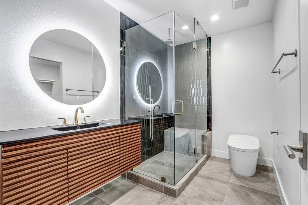 a bathroom with a shower and a sink and a mirror