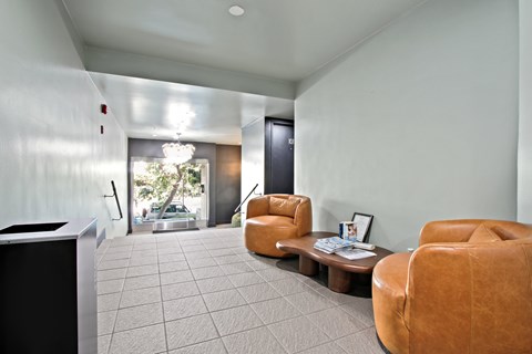 A living room with a brown leather chair and a coffee table.