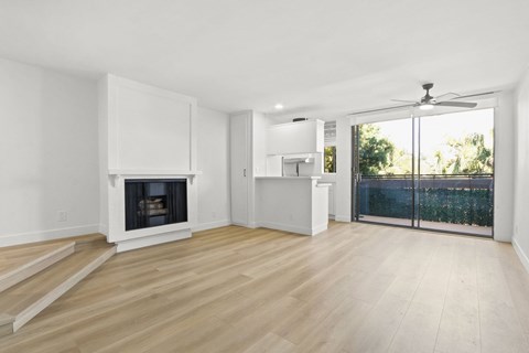 A living room with a fireplace and sliding glass doors.