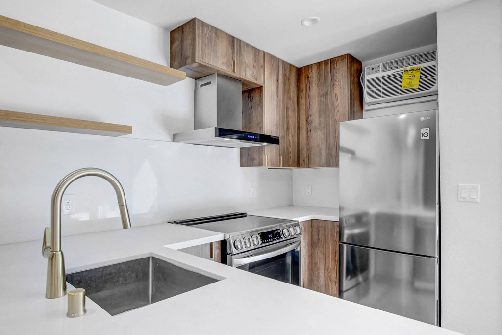 a kitchen with a stainless steel refrigerator and a sink
