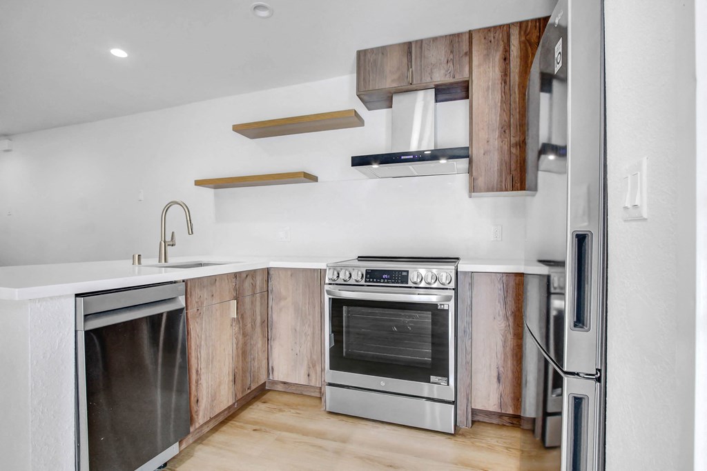 a kitchen with wooden cabinets and stainless steel appliances
