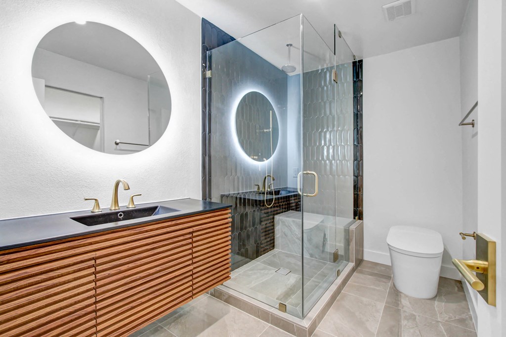 a bathroom with a toilet and a glass shower