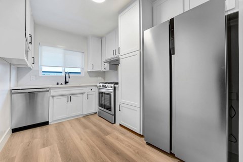 A modern kitchen with a refrigerator on the right.