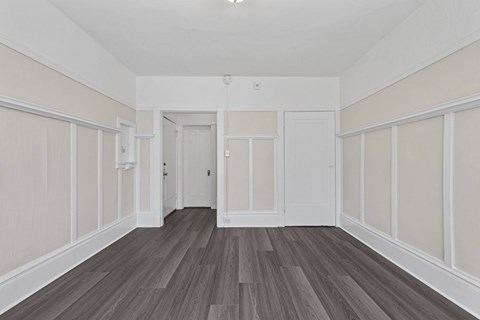 A room with wooden floors and white walls.