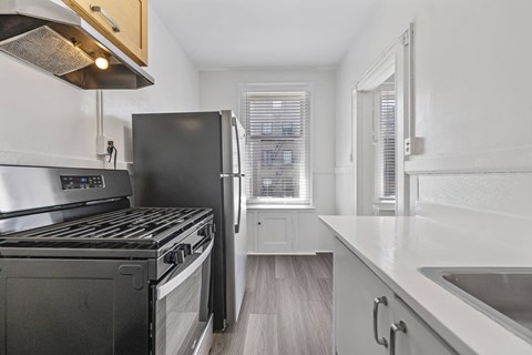 A modern kitchen with a black stove top oven and a black refrigerator.