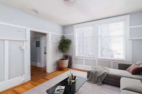 A living room with a grey couch and a coffee table.