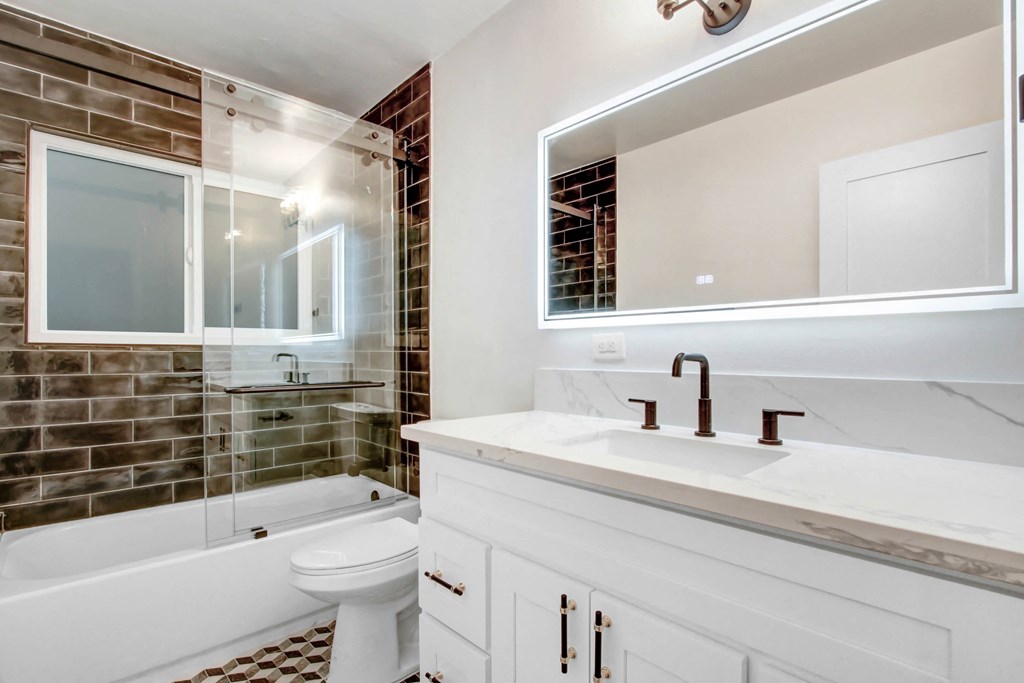 a bathroom with a sink and a toilet and a shower