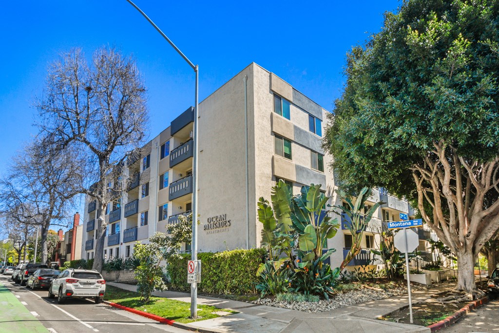 an apartment building with cars parked in front of it