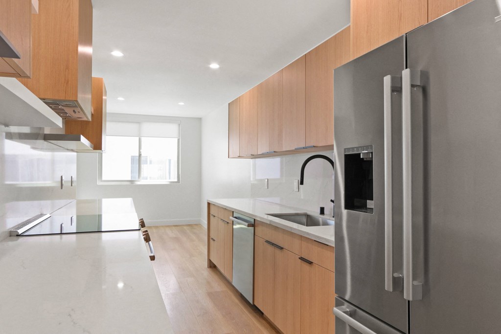 a kitchen with stainless steel appliances and wooden cabinets