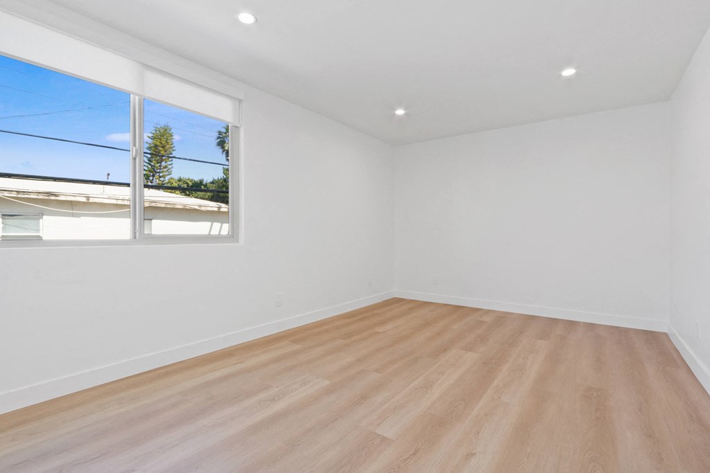 a living room with white walls and a window
