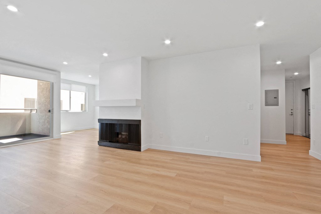 a living room with white walls and a fireplace