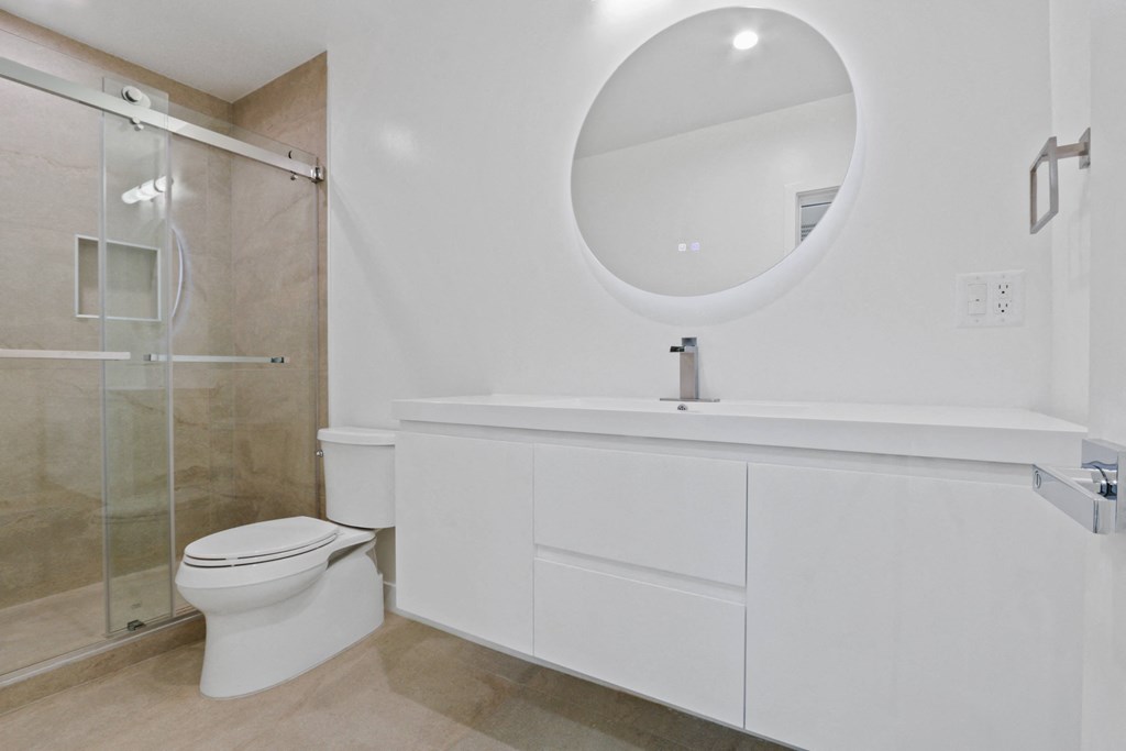 a bathroom with a toilet sink and a mirror