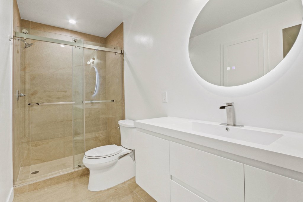 a bathroom with a toilet and a sink and a shower