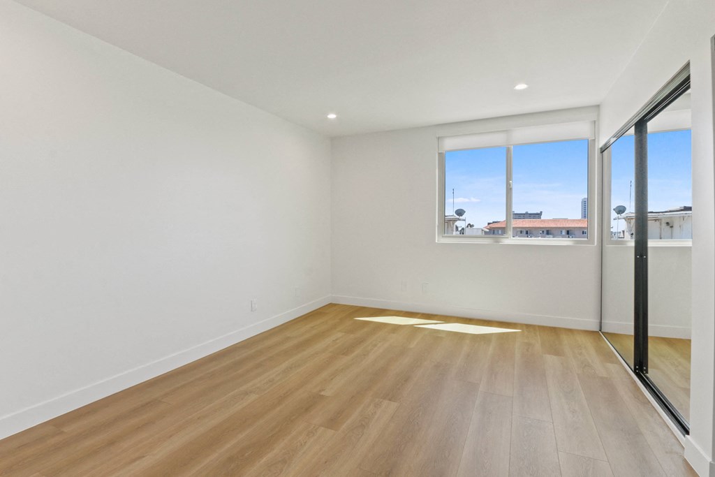 a living room with white walls and a window