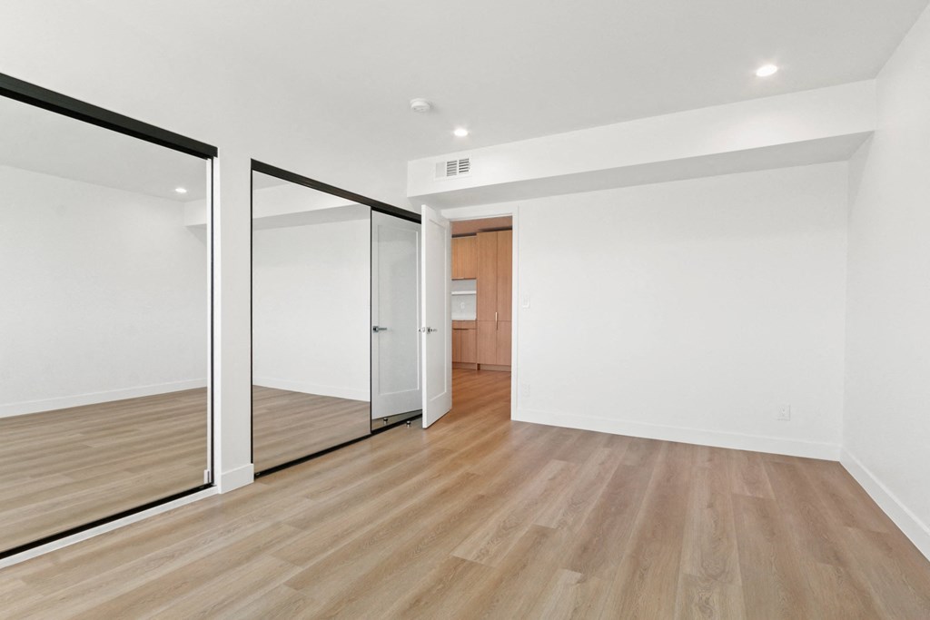 a living room with white walls and a sliding glass door