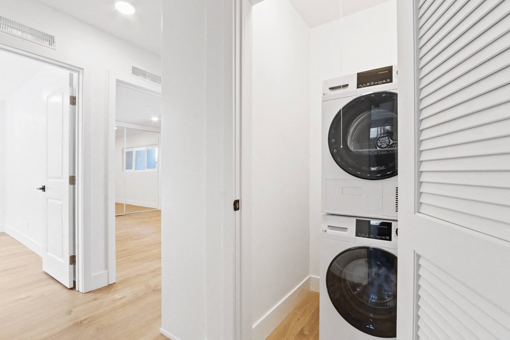 a white laundry room with a washer and dryer
