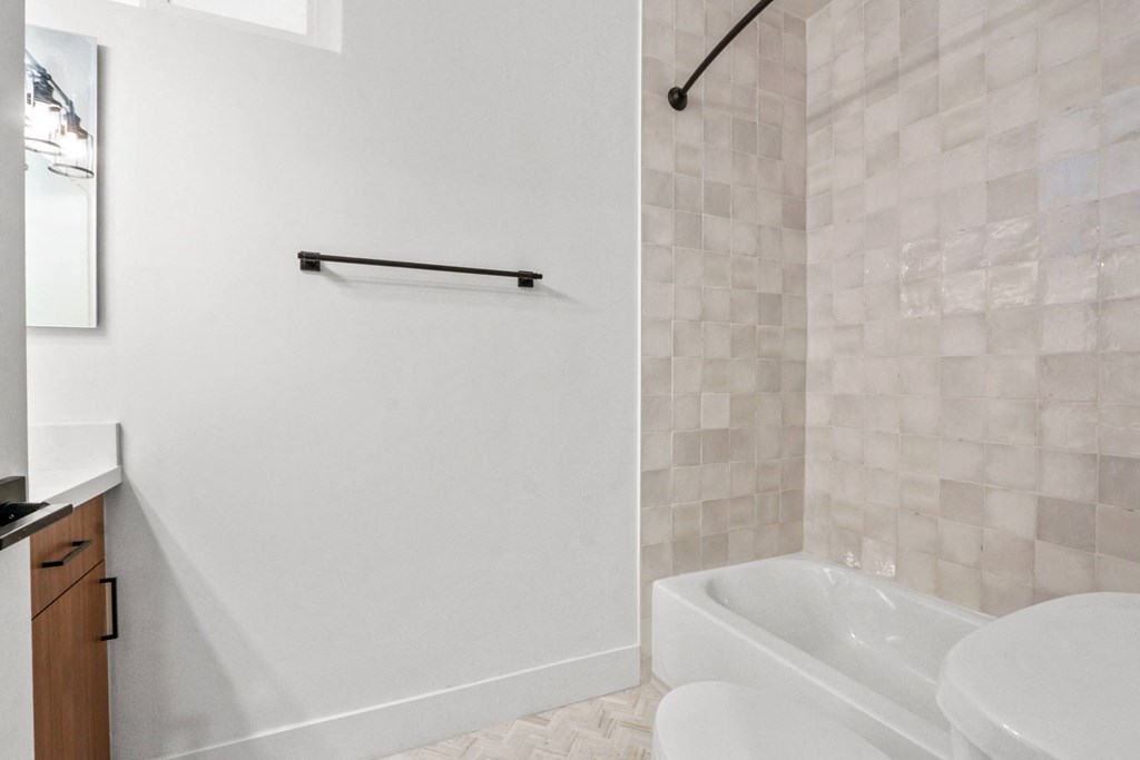 a bathroom with a tub and a sink and a shower