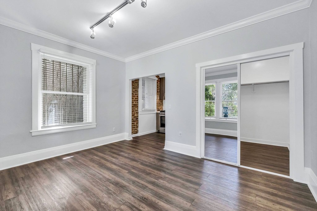 A room with a window and a door leading to another room.