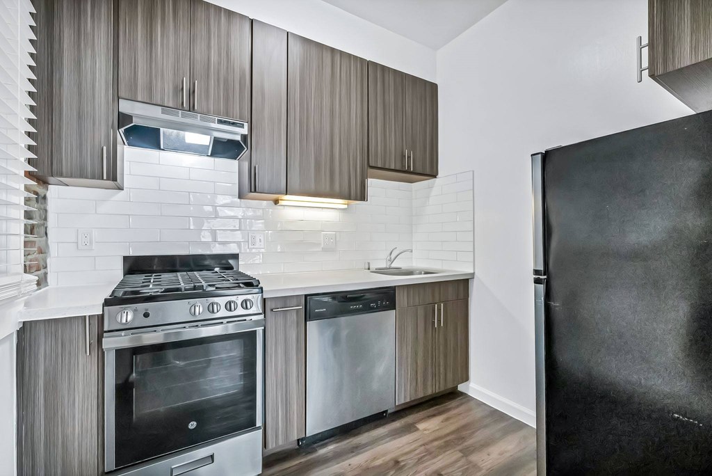 A modern kitchen with a black refrigerator.