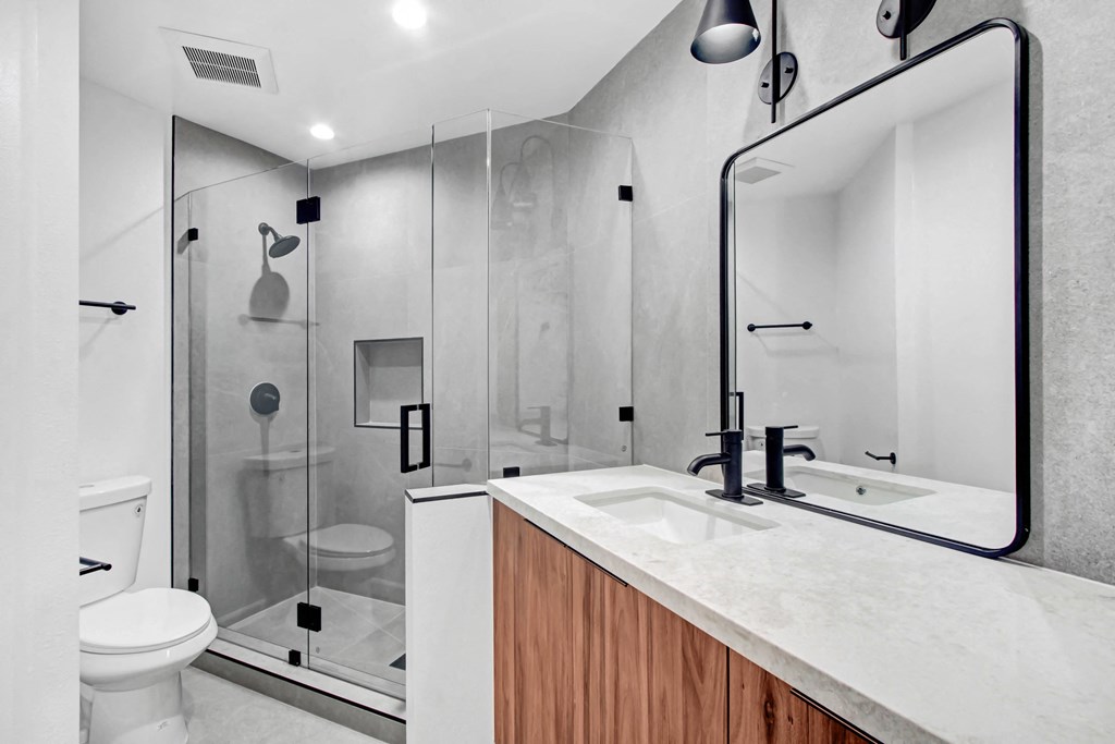 a bathroom with a sink and a shower and a toilet