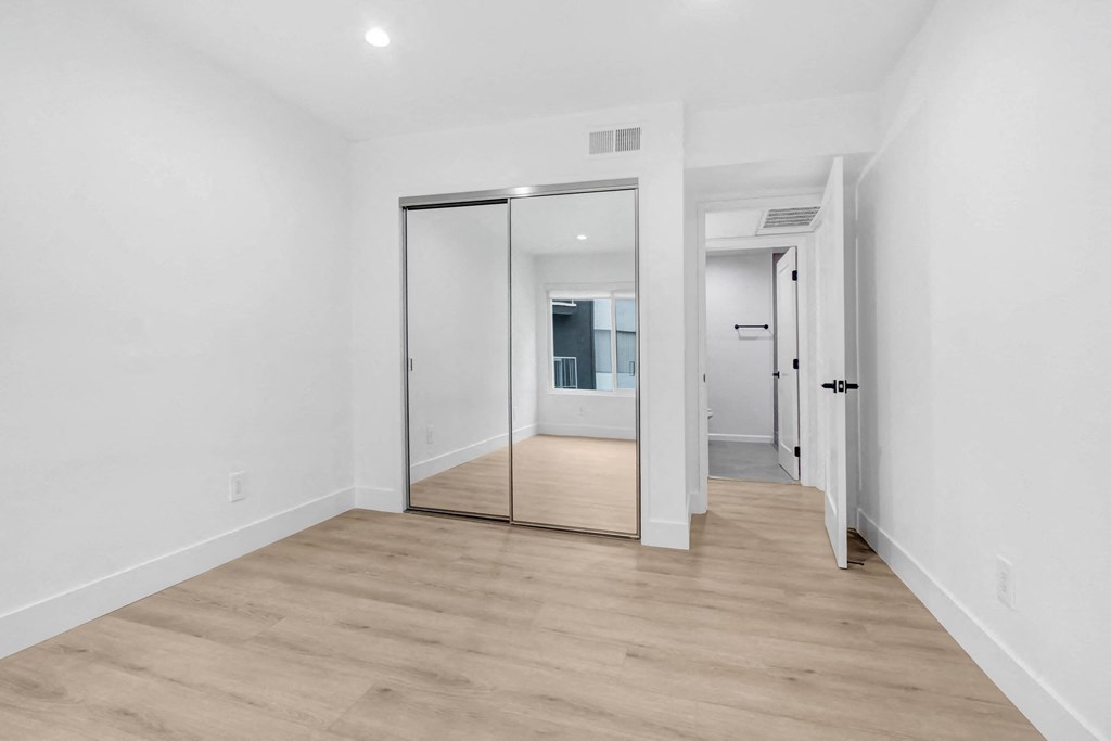 a living room with white walls and a sliding glass door