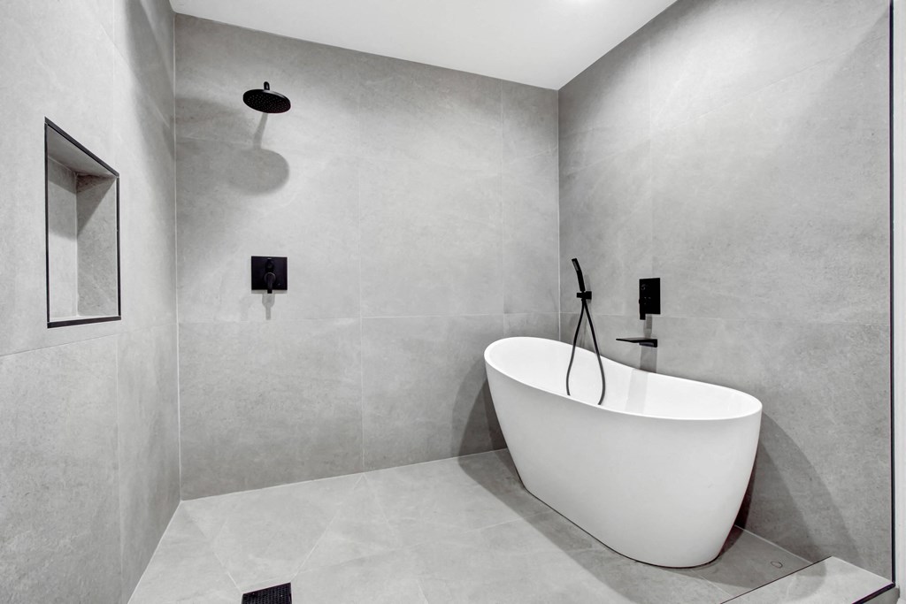 a modern bathroom with a white tub and a shower