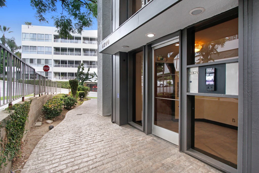 a view of the entrance to a building with a brick sidewalk