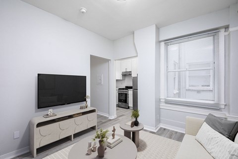 A modern living room with a flat screen TV and a coffee table.