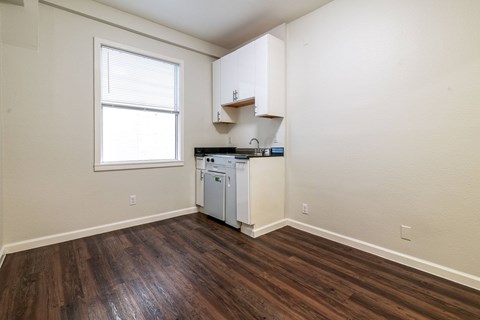 A kitchen area with a dishwasher and cabinets.