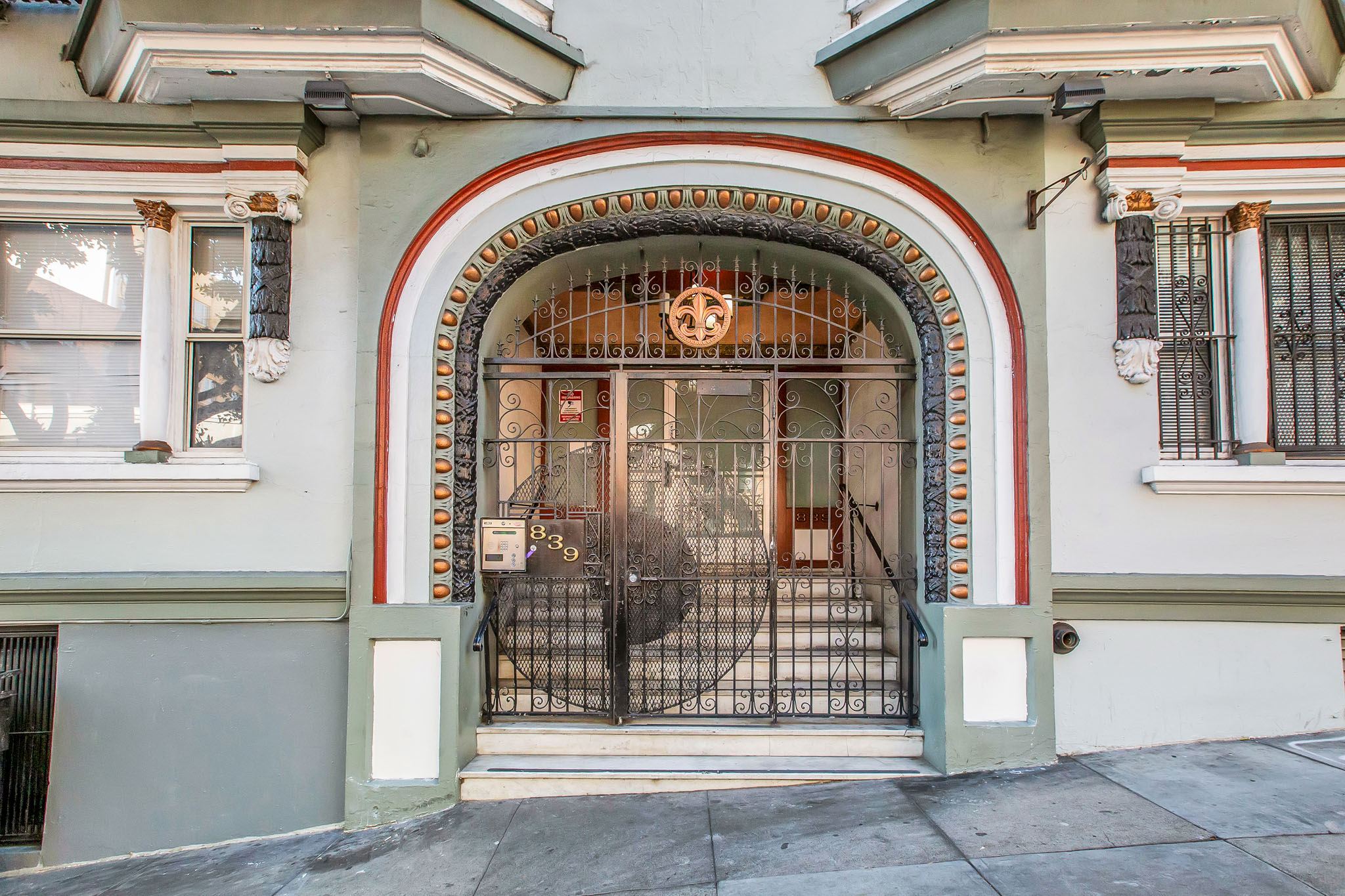 A building with a large arched doorway and a metal gate.