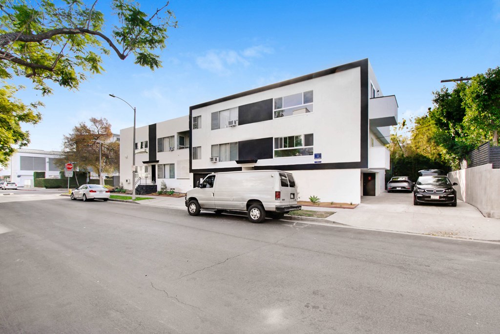 a white van parked in front of a white building