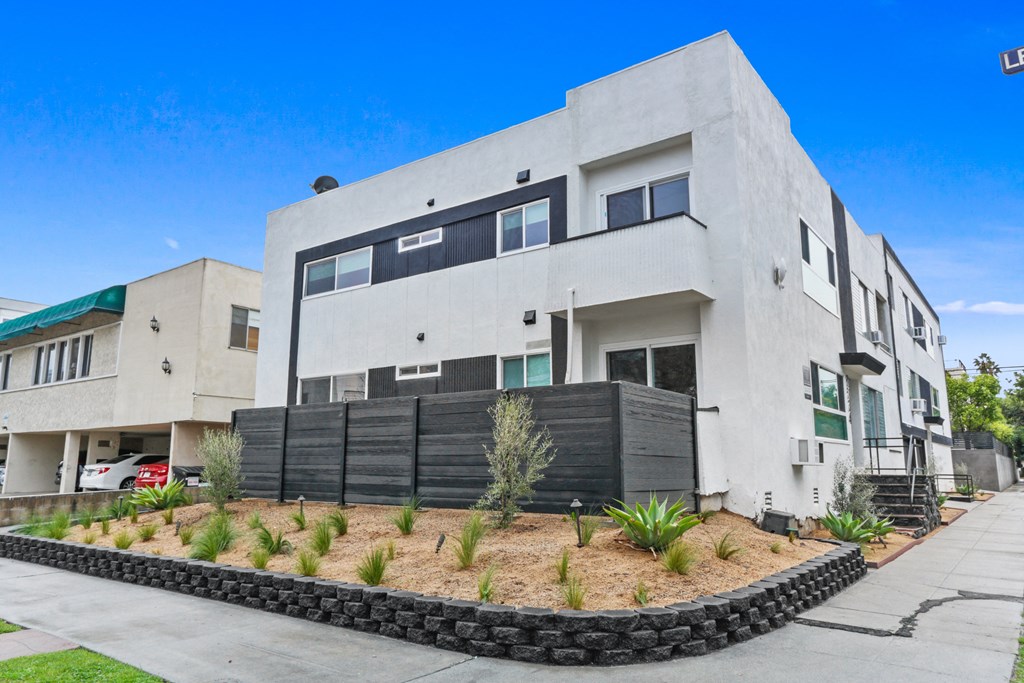 a large white house with a black fence in front of it