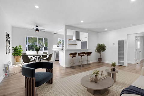 A living room with a black chair and a grey coffee table.