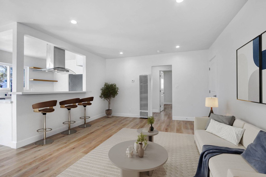 A modern living room with a bar area and a grey coffee table.