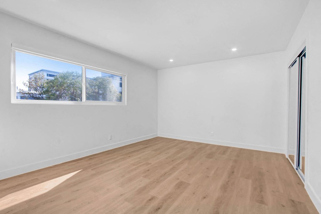 an empty room with white walls and a window