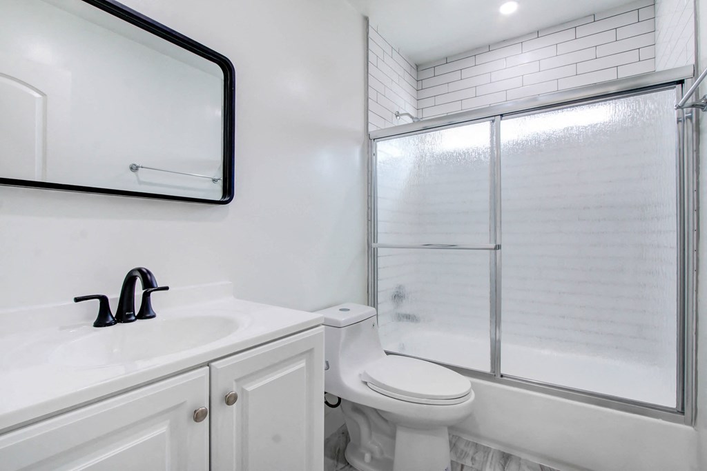 a bathroom with a sink toilet and a shower