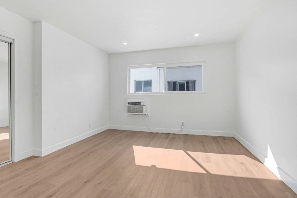a living room with white walls and a window
