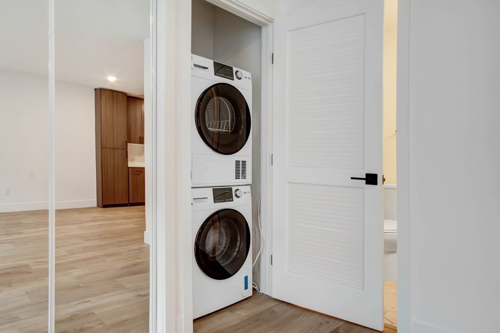 A white washing machine is in a doorway.