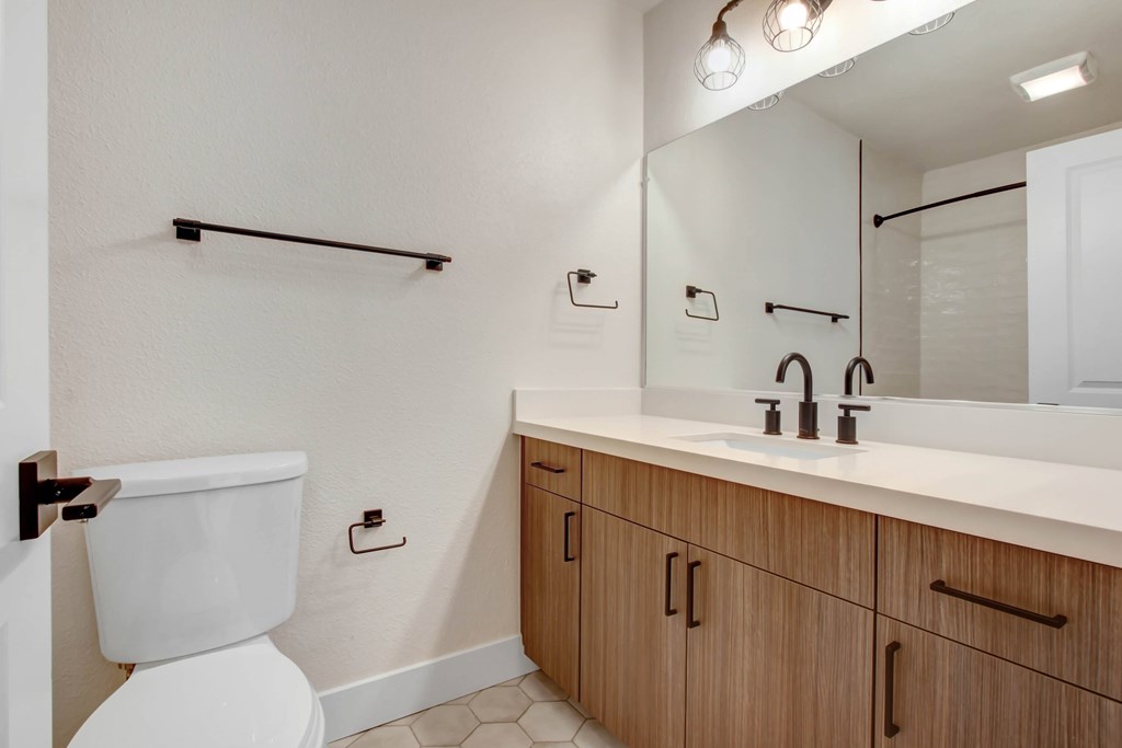 A white toilet sits next to a sink in a bathroom.