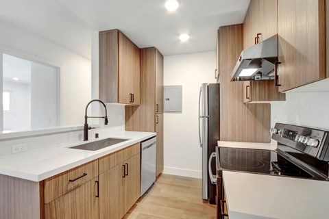 A modern kitchen with wooden cabinets and stainless steel appliances.