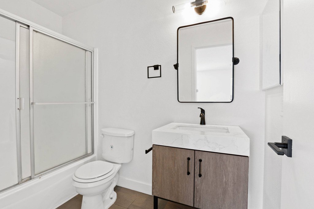 A white toilet sits next to a sink in a bathroom.