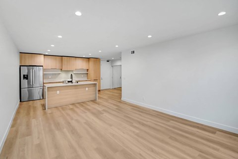 A kitchen with a wooden counter and a refrigerator.