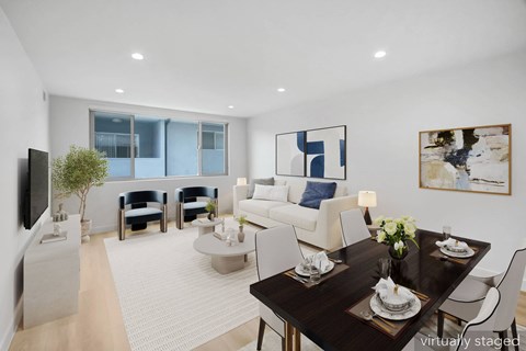 A modern living room with a dining table set for two.