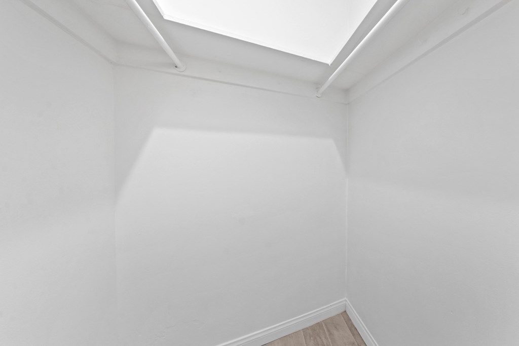 an empty room with white walls and a window