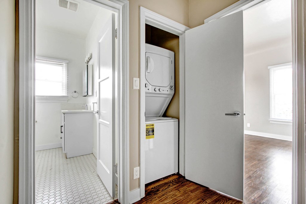 a small laundry room with a washer and dryer in it and a door