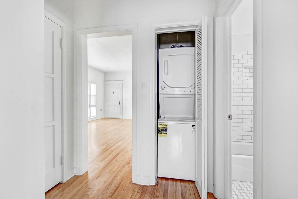 a white laundry room with a washer and dryer in it
