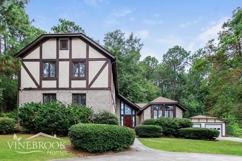 a large house with a garage and a driveway in front of it