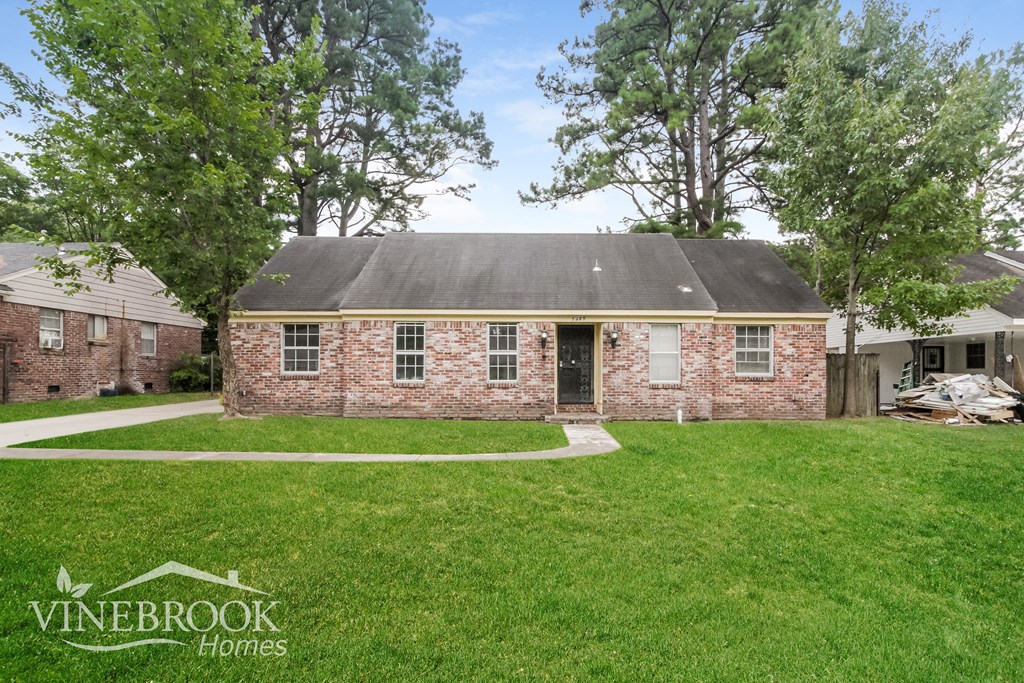 A brick house with a sign that says Vinebrook Homes.
