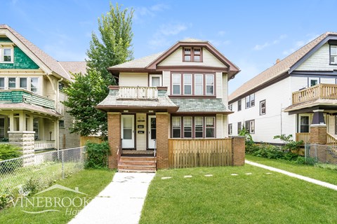 a house with a yard and a wooden fence